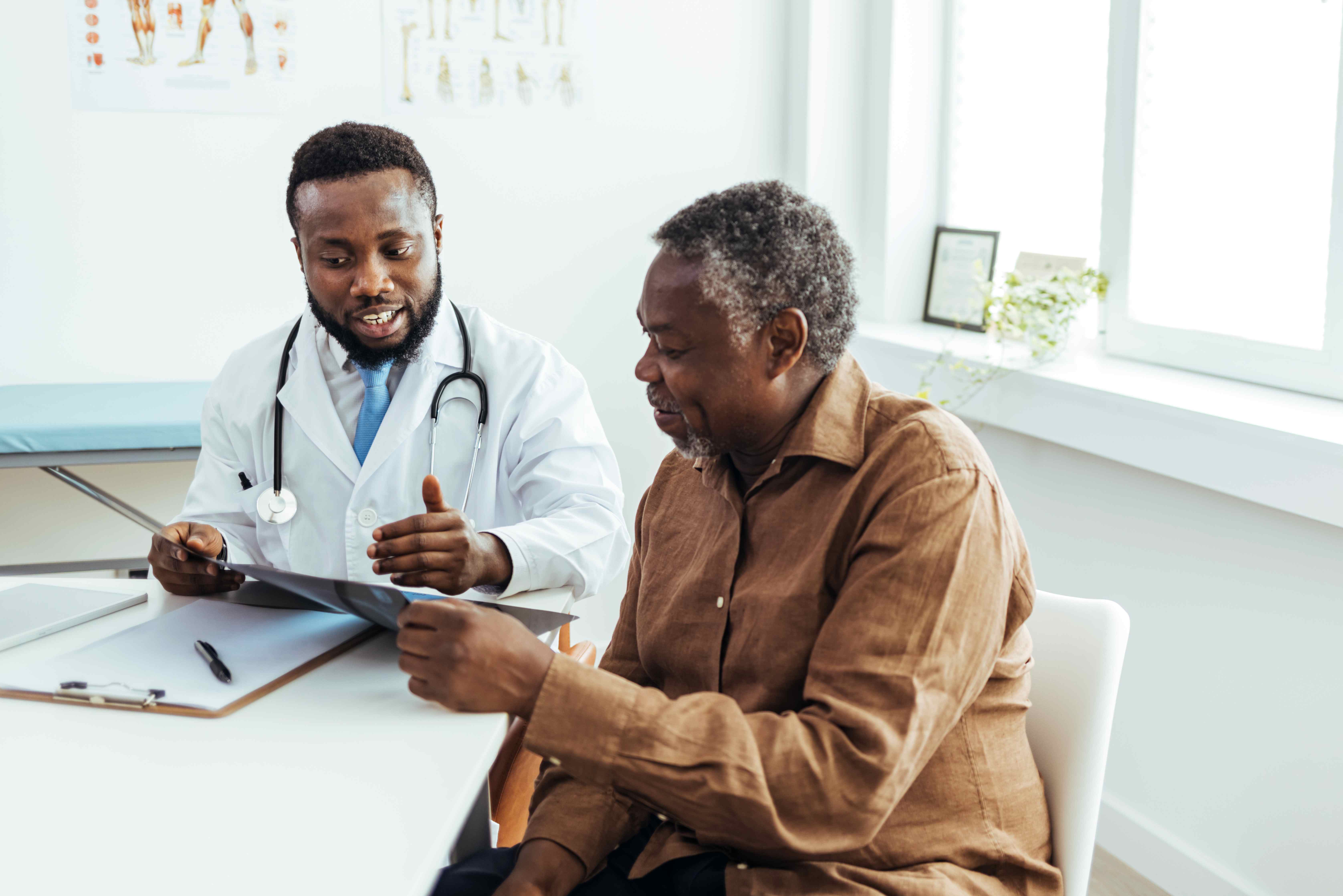 Black man talking to a doctor about a scan