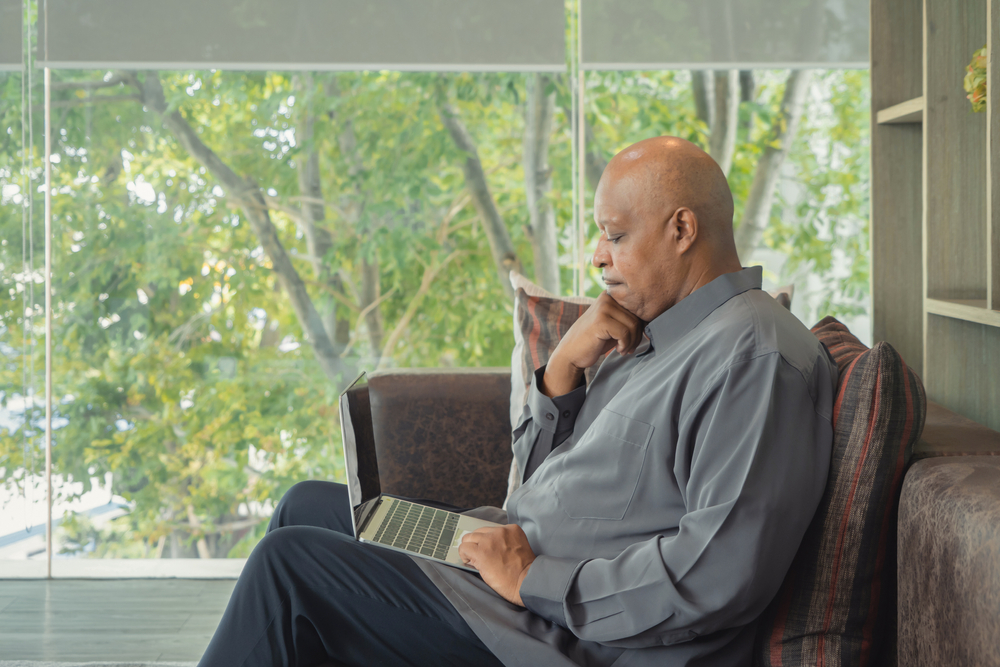 Black man looking at a laptop