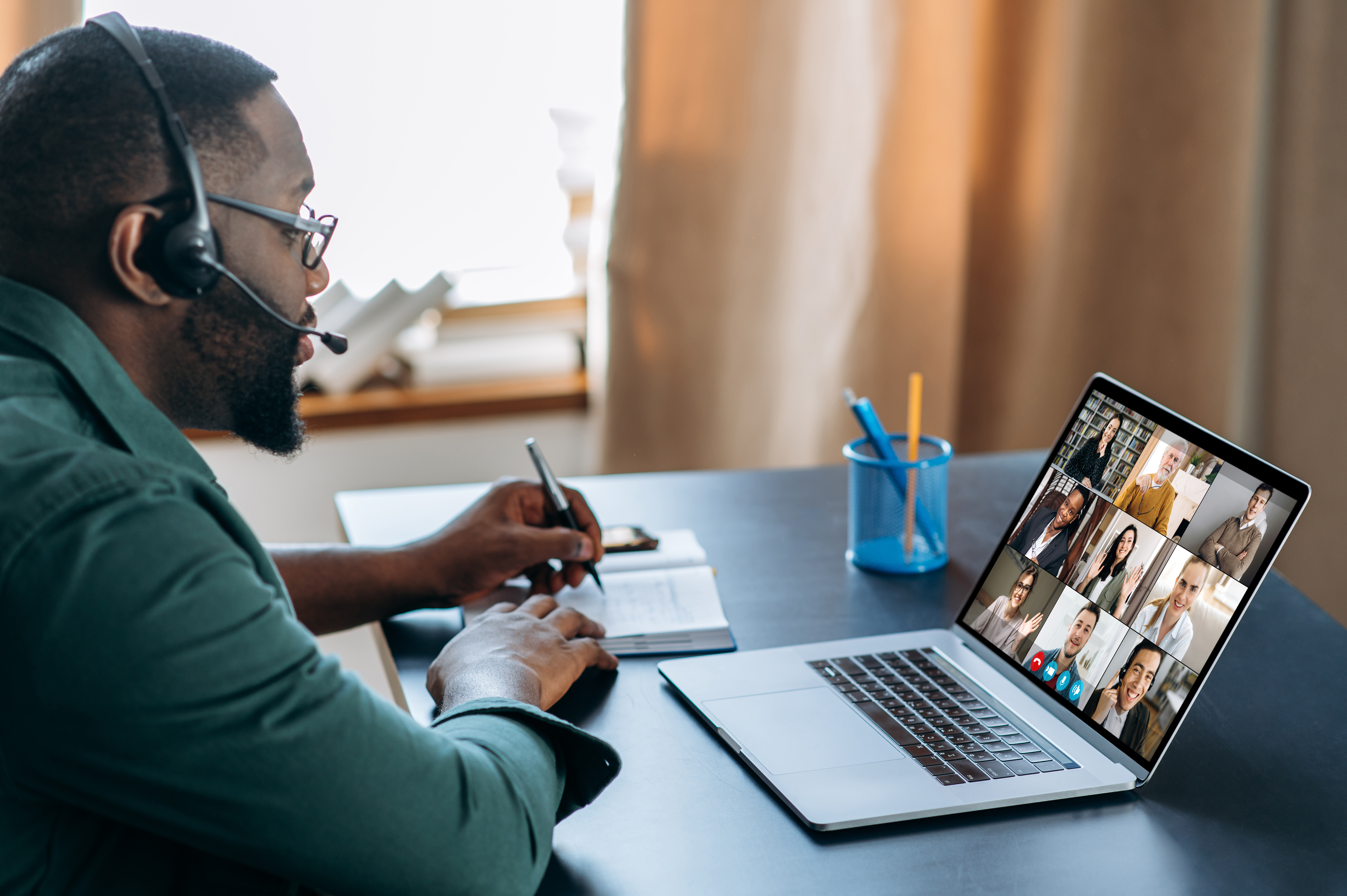 Black man working on laptop from home