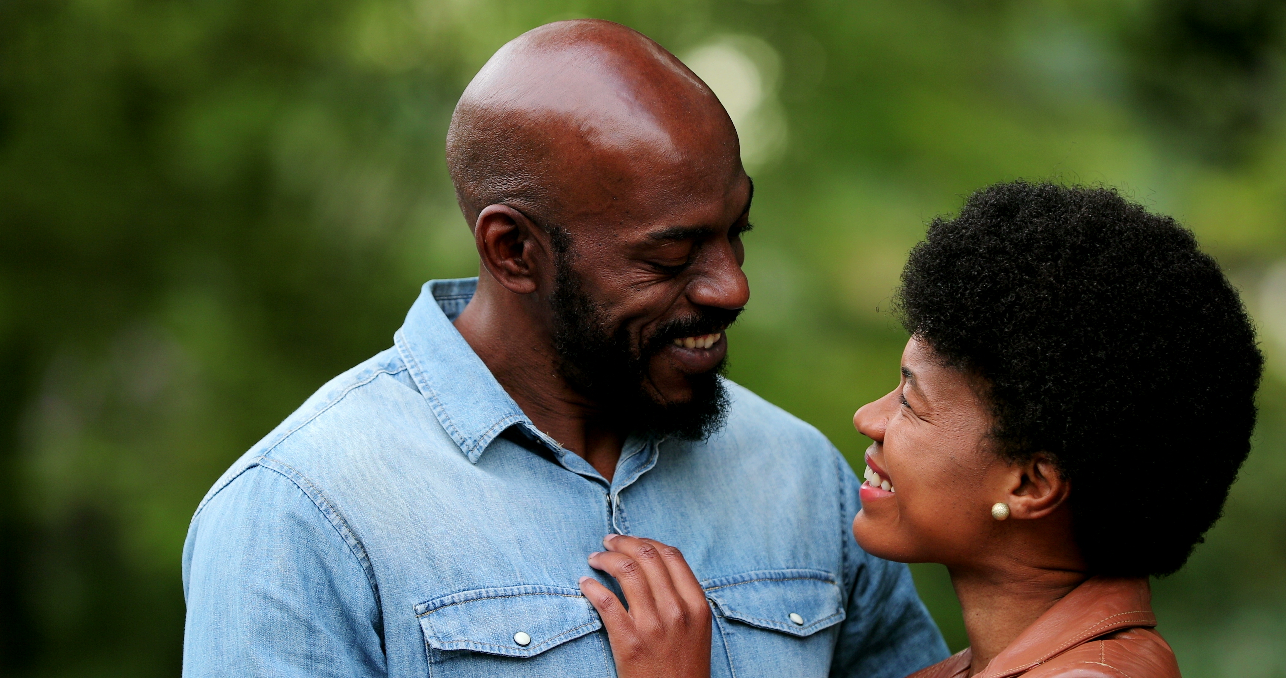 Black couple looking into one anothers eyes