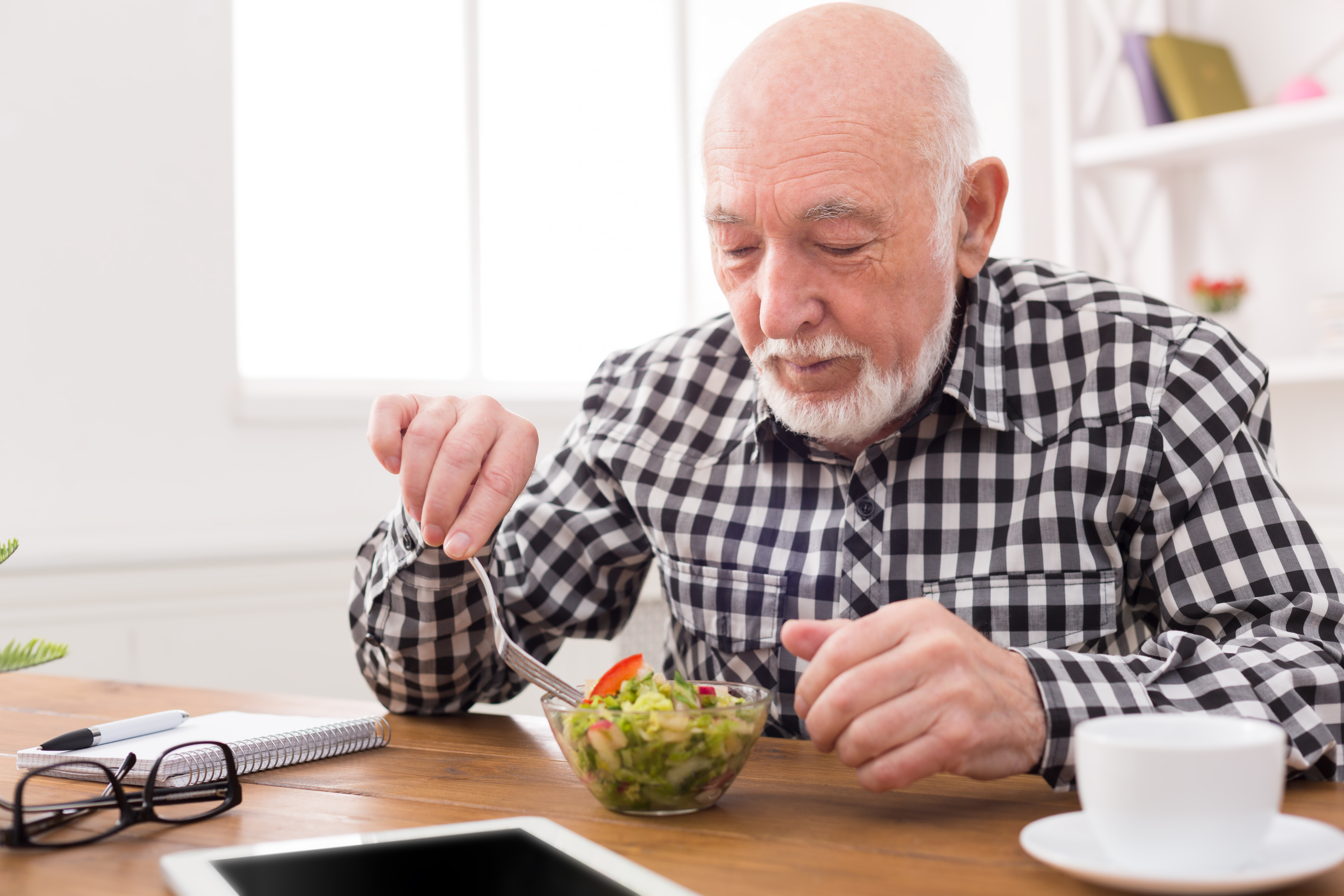 Man eating bowl of salad