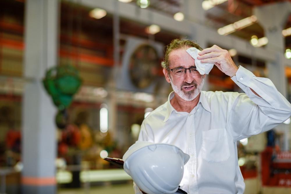 Man mopping his brow